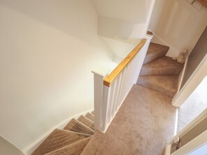 A carpeted staircase with white walls and a wooden handrail. - 4 Eve Street (Louth)
