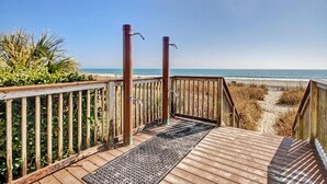 A wooden deck leading to a beach with a clear view of the ocean. - Oceanview 1BR Suite + Lazy River & Hot Tub (Myrtle Beach)