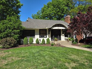 A single-story house with a gabled roof, a front porch, and a mailbox. - Walk to Brookside, Shops/Dining, 3BR, patio, backyard bar.   9 miles 2 World Cup (Kansas City)
