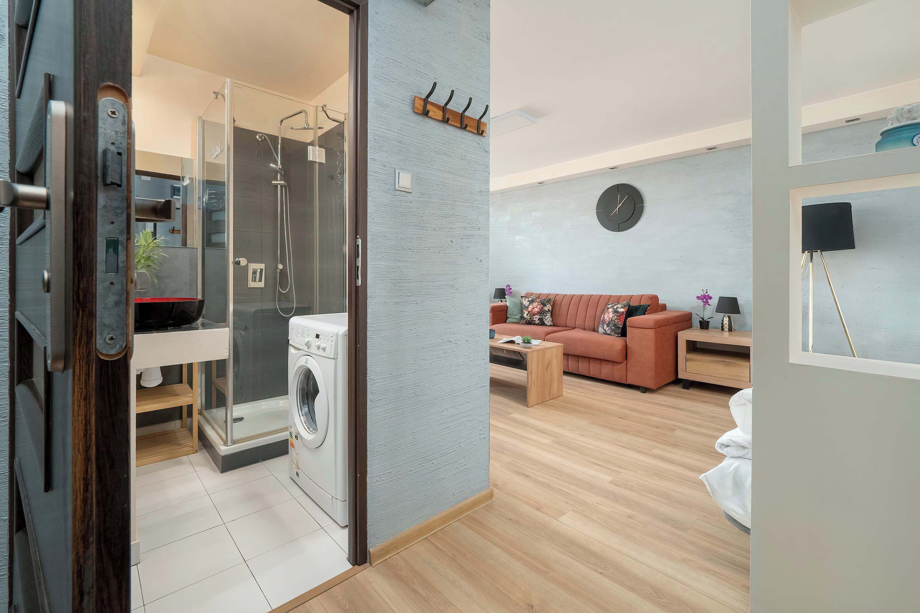 Un appartement moderne doté d’un espace buanderie, d’un canapé et d’une table basse.