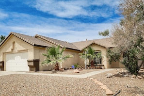 A residential house with a garage, a driveway, and a landscaped garden with palm trees and rocks. - Poolside Chills, Hiking Thrills! Las Vegas Retreat (Las Vegas)