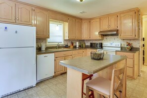 A kitchen with wooden cabinets, a refrigerator, a dishwasher, a microwave, and a stove. - 7 Mi to Lake Chatuge! Family Home w/ Office & Yard (Hayesville)