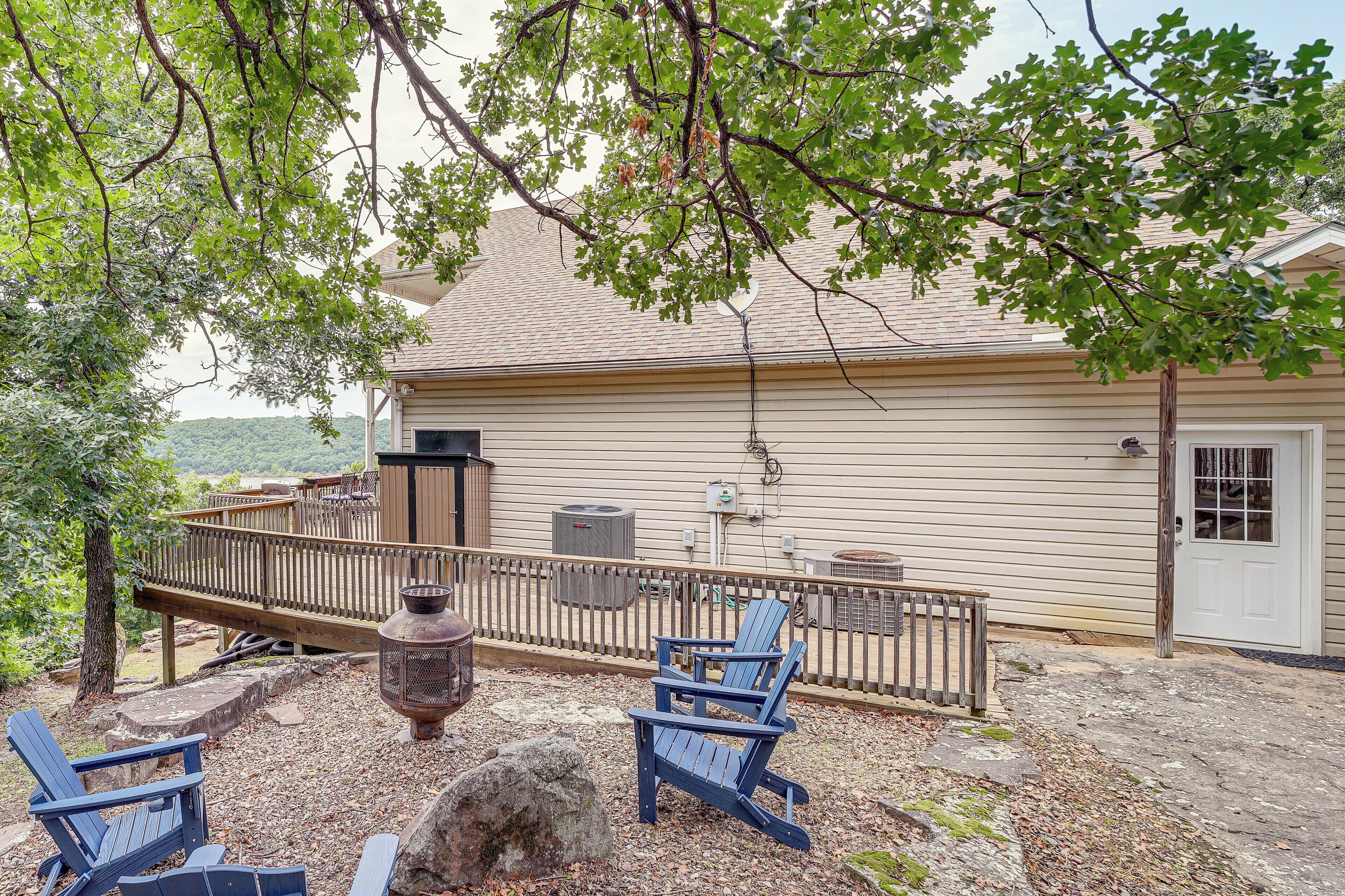 A house with a deck, outdoor seating, and a view of a mountain.