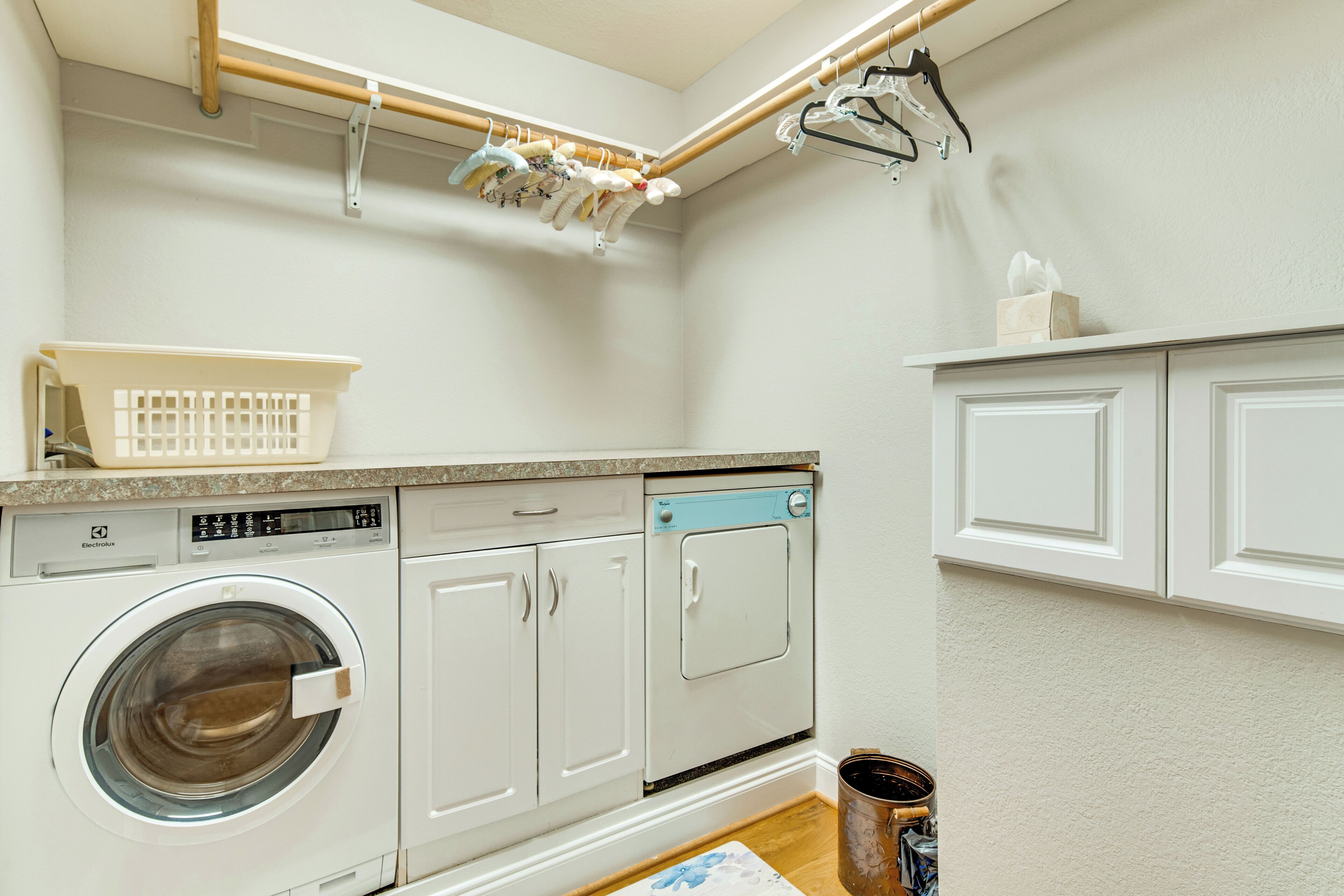 A laundry area with a washing machine, dryer, and drying rack.