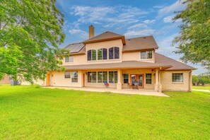 A two-story house with a large front porch, a chimney, and a garage.