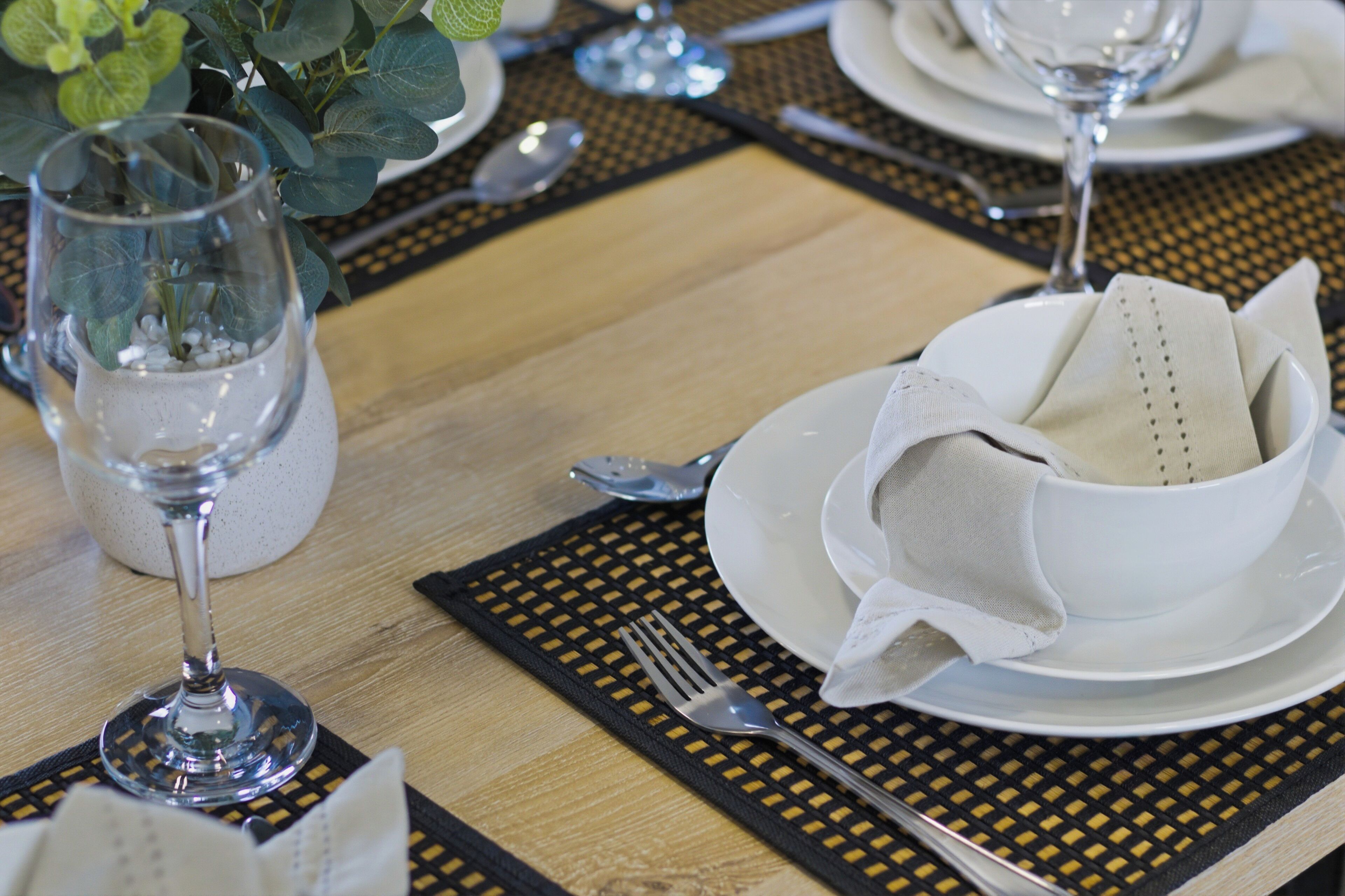 A table set for dining with plates, cutlery, and a glass of water.