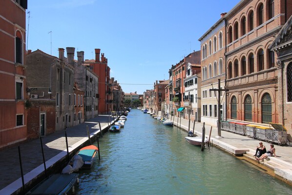A canal in a historic city with buildings on either side. - Puccini Historical Center (Venice)