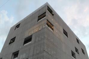 A tall building with a distinctive geometric pattern and multiple windows. - Studio in Romantic Zone at Rincon de Almas (Puerto Vallarta)