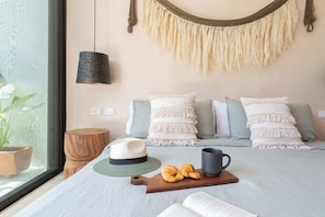 A bedroom with a bed, pillows, a hat, a mug, and a book. - Boho Style Penthouse with Private Pool 150 Wifi (La Veleta)
