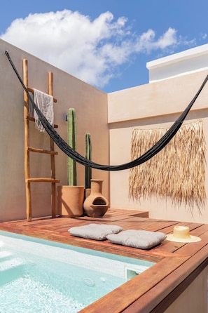 A wooden deck with a hot tub, a hammock, and two cacti. - Boho Style Penthouse with Private Pool 150 Wifi (La Veleta)
