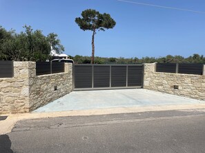 A gated driveway with stone walls and a metal gate. - One beautiful accommodation with good atmosphere & comforts!!! (Greece City)