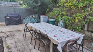 A covered outdoor table with chairs, a barbecue grill, and a covered seating area. - Bed and breakfast in the center of Migennes, near train station and amenities (Migennes)