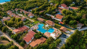 An aerial view of a residential area with houses, a swimming pool, and a beach. - An oasis of peace where you can reconnect with nature and relax (Calabria)