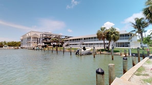 A waterfront hotel with a dock, a covered boat launch, and a private property sign. - Driftwood Landing 18- Isles of Capri Vacation Resort. (Naples)