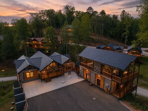 A lodge with multiple cabins, a central building with a balcony, and a driveway. - Pool, Hot tub, Game Room, Gazebo, Sleeps 36 (Sevierville)