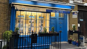 A blue storefront with a sign reading 'RUS Limited' and a phone number. - Blue Door Stay - 5 Bedroom Apartment in London, UK (London)