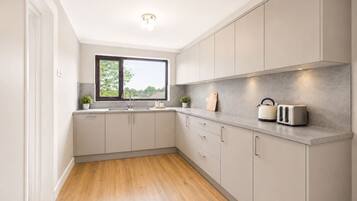 Fridge, toaster, cookware/dishes/utensils, dining tables