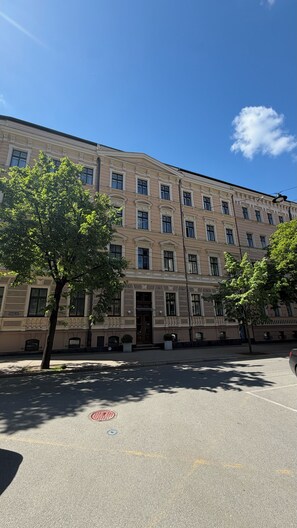 A multi-story building with a classical architectural style, featuring symmetrical windows and decorative moldings. - Scandinavian Skylight Loft - Riga Quiet Center - Historic Building, AC (Rīga)