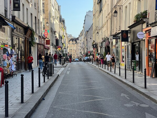 A street lined with shops, including a Thai restaurant and a tabac store. - 3 bedroom apartment (Paris)