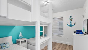 A room with bunk beds, a desk, and a window with blinds. - Beachy 2BR Escape with Pool Views  | St. Martin Beachwalk Villa 314 (Destin)