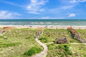 A beach with wooden boardwalks, a sandy beach, and the ocean. - Oceanfront Condo w/ Panoramic Views, Whirlpool Tub & Beach Access (Emerald Isle)