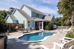 A house with a swimming pool, outdoor seating, and a fenced yard. - Blue Byrds - 4 Bedroom Home (Emerald Isle)