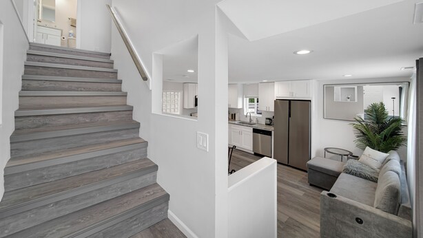 A modern interior with a staircase, kitchen, and living area. - Bright & Modern 2-Story Near Northwestern (Evanston)