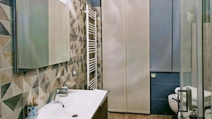 A bathroom with a white sink, a towel rack, a toilet, and a shower area. - B&B La Rocca  (Spoleto)