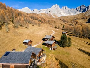 A mountainous landscape with wooden cabins and a clear sky.