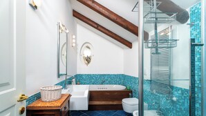A bathroom with a bathtub, a toilet, a sink, and a shower area. - YourHome - La Terrazza nel Blu (Piano di Sorrento)