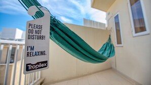 A hammock with a sign attached to it, a building, and a clear sky. - Charming bright penthouse with 3 Terraces JCUT2-1 (Swieqi)