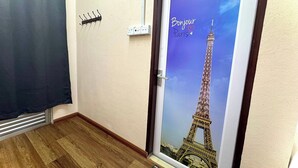 A door with a 'Bonjour Paris' sign and the Eiffel Tower photo. - Hotel Rs Inn (Pasir Mas)