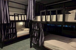 Bunk beds with curtains, a tiled floor, and a window with a view. - Terminal Garage (Phuket)