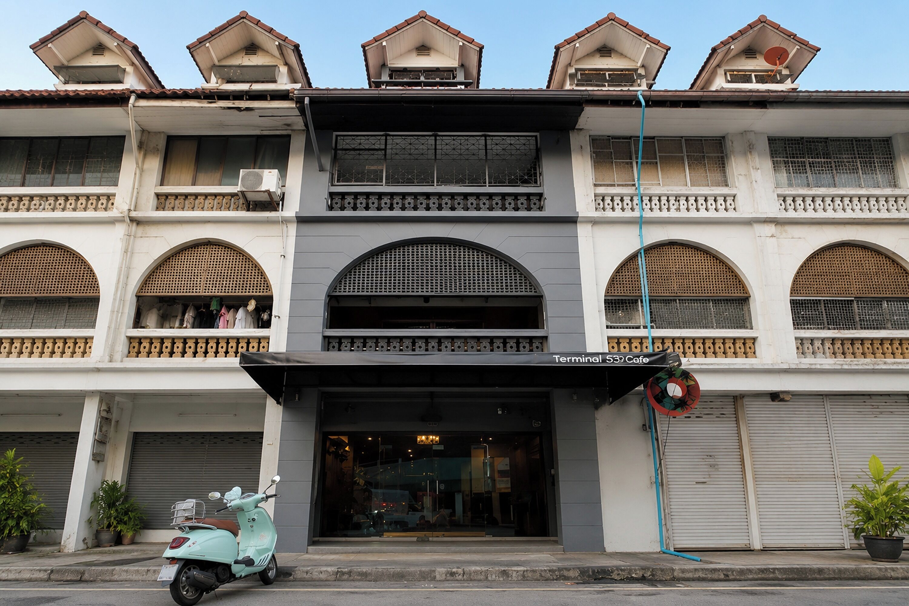 A two-story building with a cafe named 'Terminal 53 Cafe' on the ground floor.