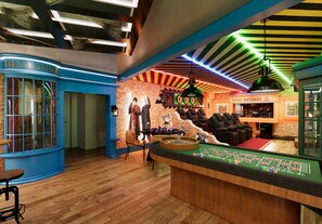 A casino interior with a roulette table, blackjack table, and a sign for 'Best Quality Potages.' - 8BR house at Windsor Cay Resort (Clermont)