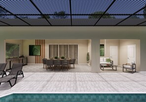 A covered outdoor area with a pool, a dining table with chairs, and a seating area with a sofa and armchairs. - 8BR house at Windsor Cay Resort (Clermont)