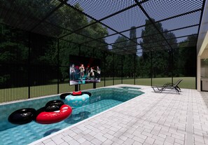 An indoor swimming pool with inflatable rings, a stage, and a seating area. - 8BR house at Windsor Cay Resort (Clermont)