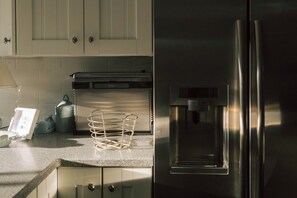A kitchen with stainless steel appliances, a built-in oven, and a water dispenser. - Quaint 2-bedroom, ground floor Condo with water views. Walk to downtown Lewes! (Lewes)