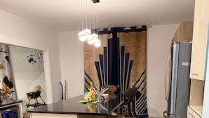 A modern kitchen with a central island, a built-in wine cooler, and a refrigerator. - Huge, immaculate Chris manor house 5 minutes from amusement park and gym (Saint-Augustin-de-Desmaures)