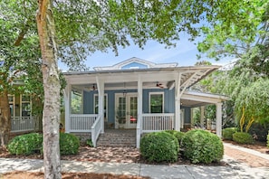 A two-story house with a porch, a covered front porch area, and a brick pathway leading to the entrance. - ☀️Jaybird Bungalow-Bikes-Community Pool☀️ (Santa Rosa Beach)