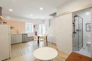 A compact kitchen with a dining area, a small refrigerator, a sink, and a fire extinguisher. - Best Houses 41 - Peniche Ocean Loft (Peniche)