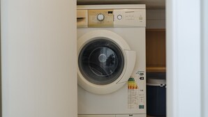 Une machine à laver à chargement frontal, dotée d’un panneau de commande, d’un compartiment à lessive et d’une étiquette indiquant qu’il s’agit d’un modèle à chargement frontal.