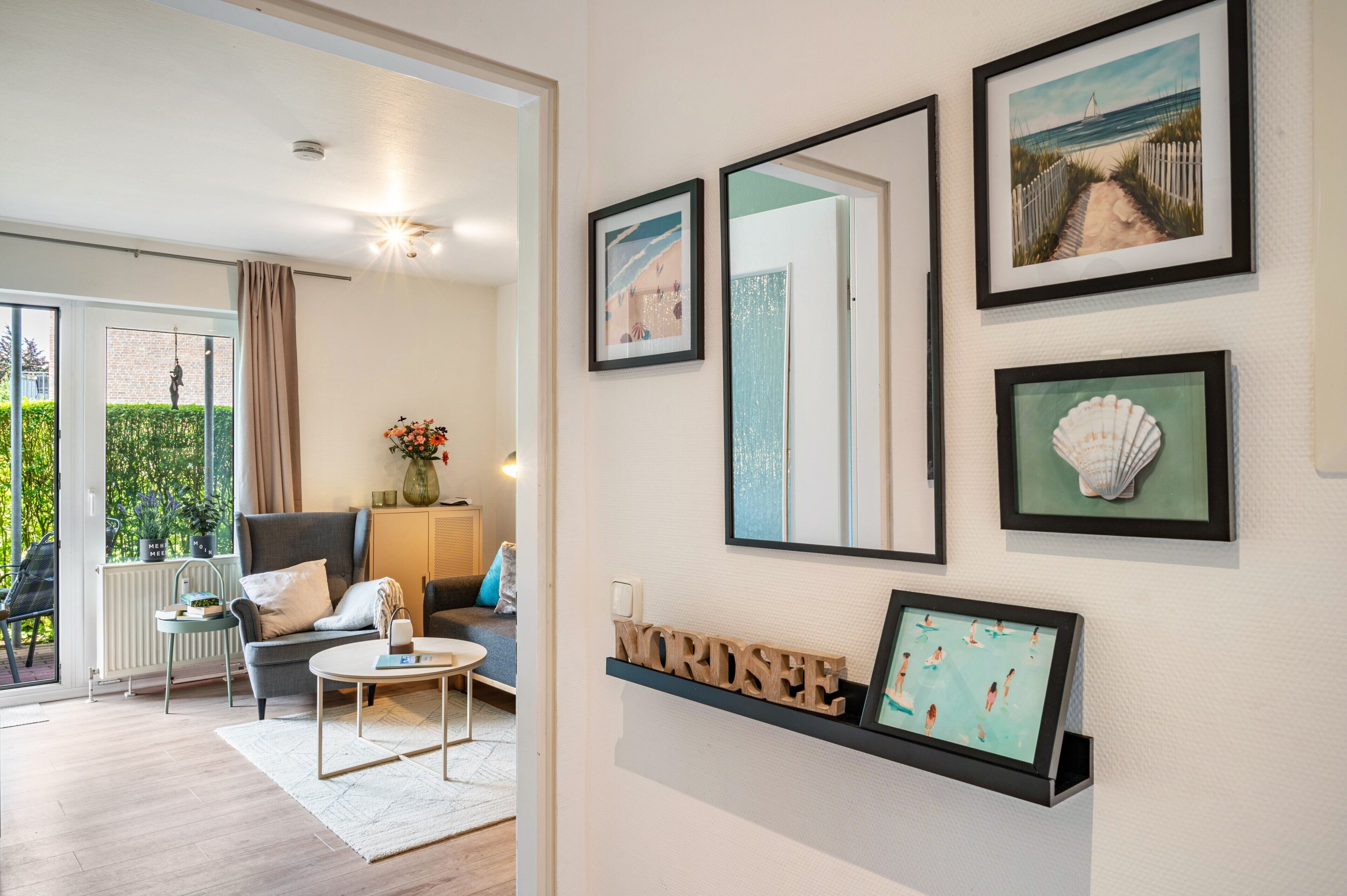 Ein modernes Wohnzimmer mit einer Couch, einem Couchtisch und Kunstwerken an der Wand.