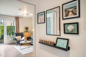A modern living room with a sofa, coffee table, and artwork on the wall.