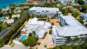 A resort with multiple buildings, a swimming pool, and a marina. - Olde Marco Inn #403, Waterfront Island Escape (Marco Island)