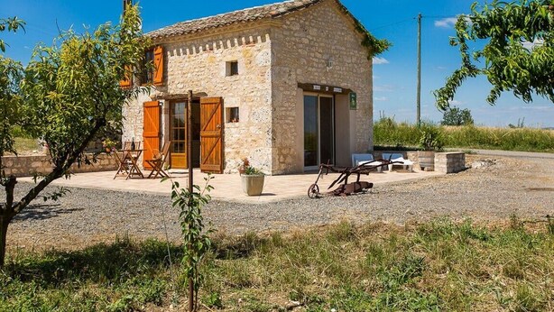 A stone building with a door, windows, and a small porch area. - Holiday Home "La Cabane du Vigneron" with Shared Pool, Private Terrace & Air Conditioning (Donnazac)