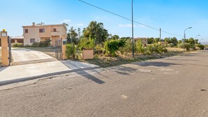 Una calle residencial con casas, aceras y farolas.