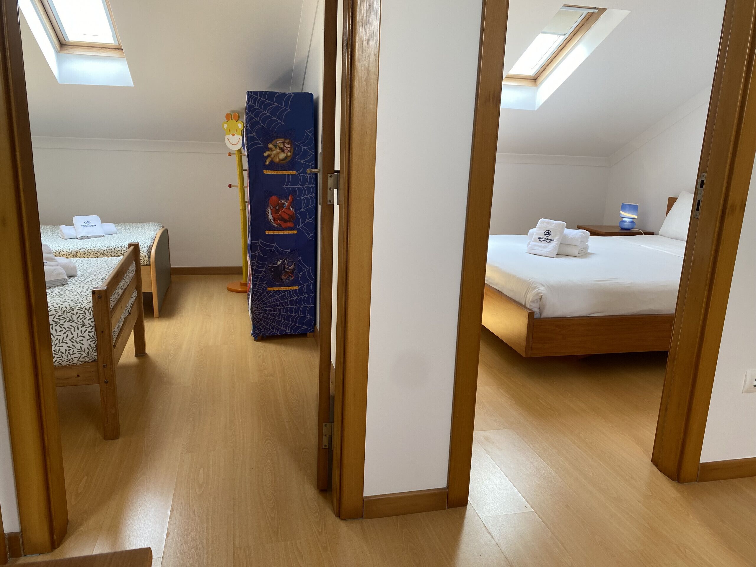 A room with a bed, a desk, and a wardrobe.