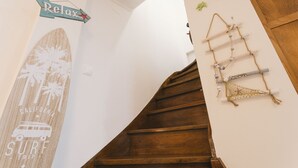 Eine Holztreppe mit Surfbrettdetails und einem 'Relax'-Schild.