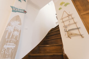 Eine Holztreppe mit Surfbrettdetails und einem 'Relax'-Schild.